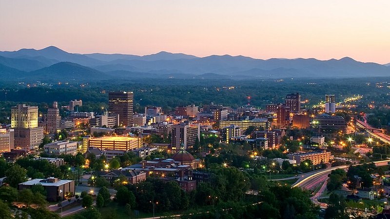 Downtown Asheville skyline at dusk against the Blue Ridge Mountains