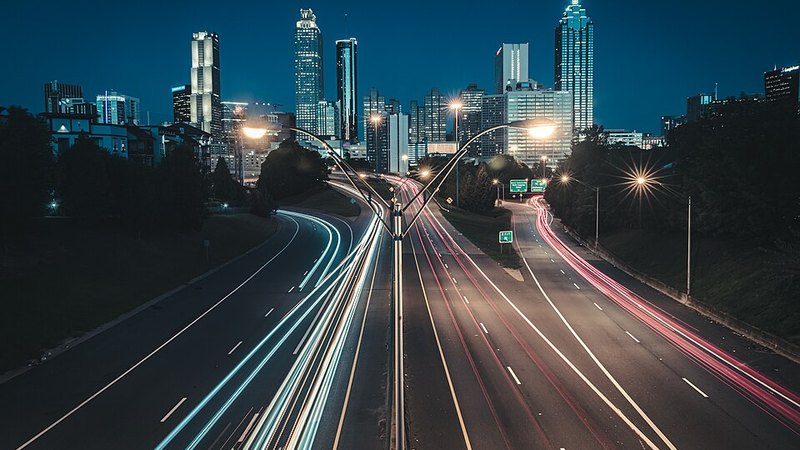 Atlanta skyline at dawn with traffic light trails, viewed from Jackson Street Bridge.