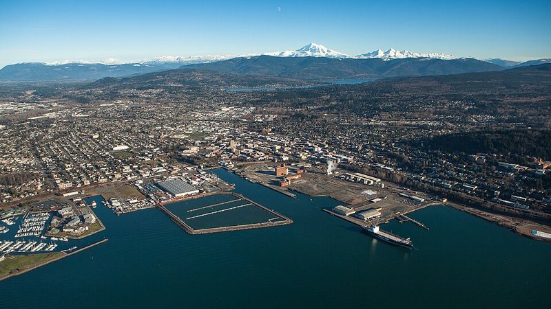 Aerial view of Bellingham, Washington, with its waterfront and Mount Baker in the distance.