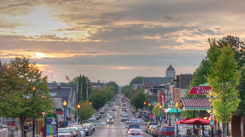 Kirkwood Avenue in Bloomington, Indiana, beneath a sunset sky.