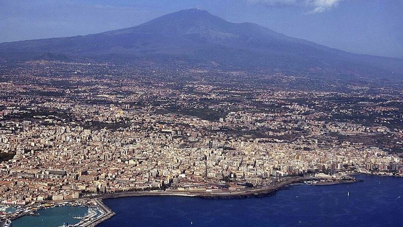 Catania, its coastline, and Mount Etna seen from above, Italy.