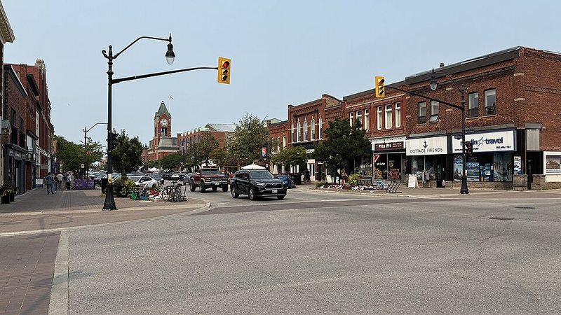 Historic storefronts and the distant clock tower along Hurontario Street in Collingwood, Ontario.