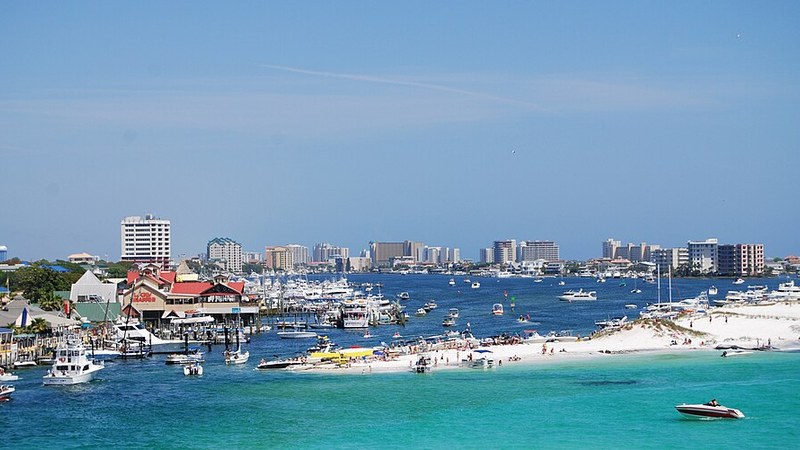 Destin Harbor, boats, and sandy shoreline, Florida.