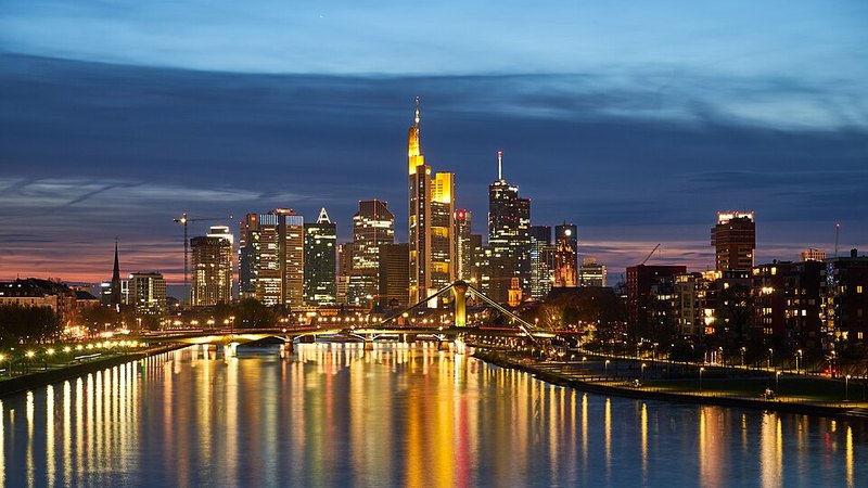 Frankfurt skyline illuminated above the Main River at night
