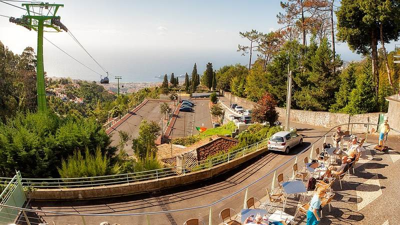 Cable cars and a hillside terrace overlooking Funchal, Madeira, Portugal.