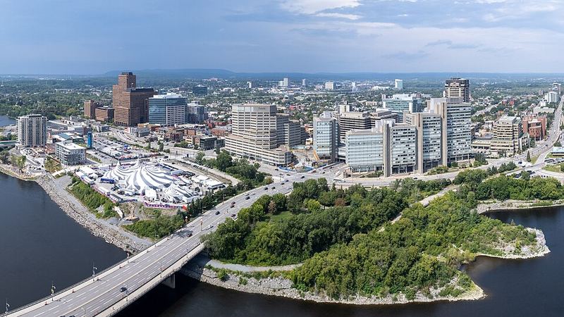 Gatineau skyline and riverfront buildings beside a bridge across the Ottawa River.