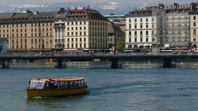 A yellow Mouette boat and the Pont des Bergues in Geneva, Switzerland.