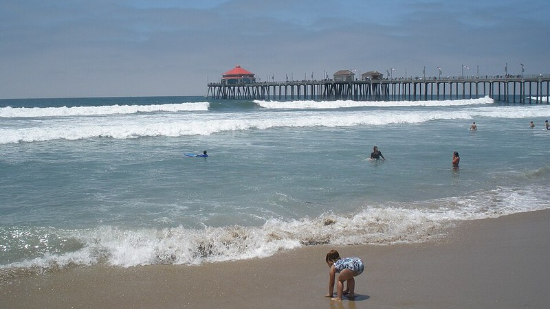 Surf and the municipal pier in Huntington Beach, California.