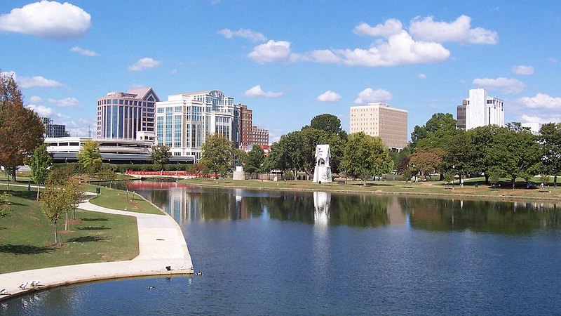 Downtown Huntsville skyline reflected in Big Spring Park's lake in Alabama