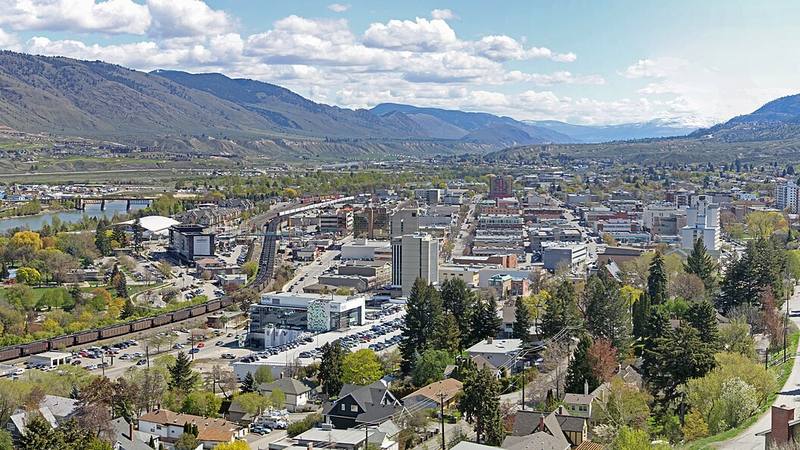 Downtown Kamloops beside the Thompson River, surrounded by hills.