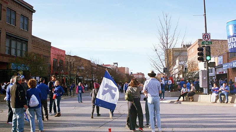 People gather along Massachusetts Street in downtown Lawrence, Kansas.