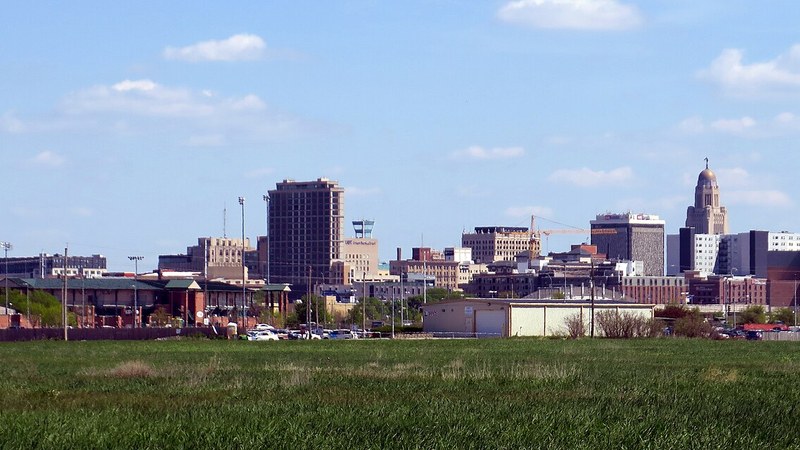 Downtown Lincoln skyline and the Nebraska State Capitol.