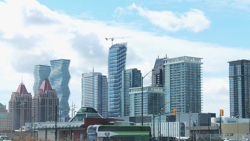 Modern downtown towers and transit vehicles in Mississauga, Ontario.