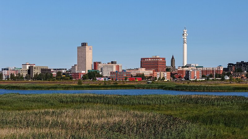Downtown Moncton across the Petitcodiac River, with marsh grasses in the foreground.