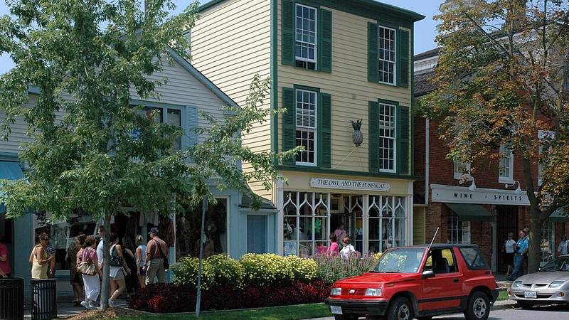 Historic shops and summer visitors on Queen Street in Niagara-on-the-Lake, Ontario.