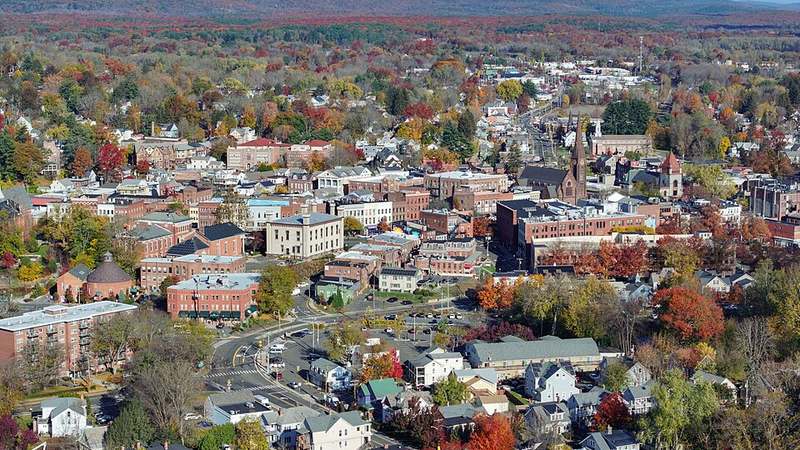 Aerial view of downtown Northampton, Massachusetts, surrounded by autumn foliage.