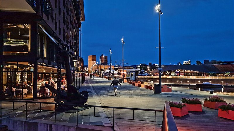 Aker Brygge waterfront promenade in Oslo, Norway, at dusk.