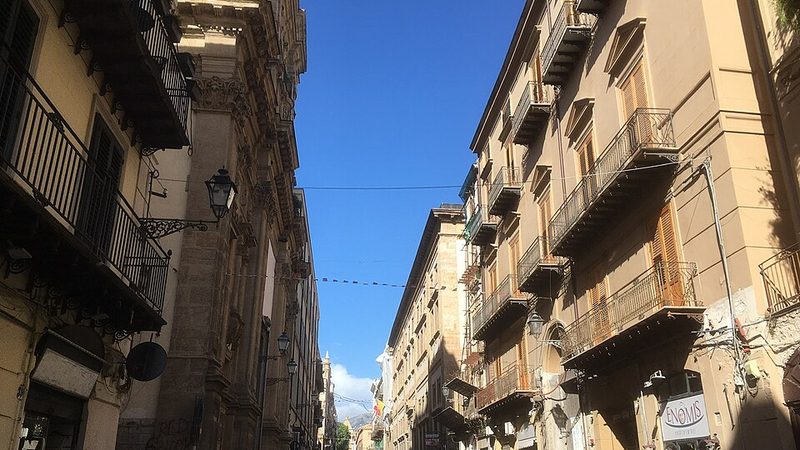 Balconies and historic buildings along a street in Palermo, Sicily.