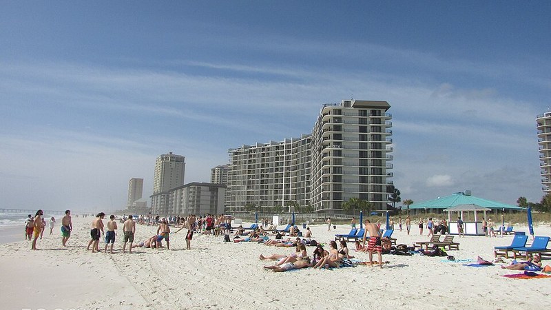 Beachfront hotels and people on the sand at Panama City Beach, Florida.