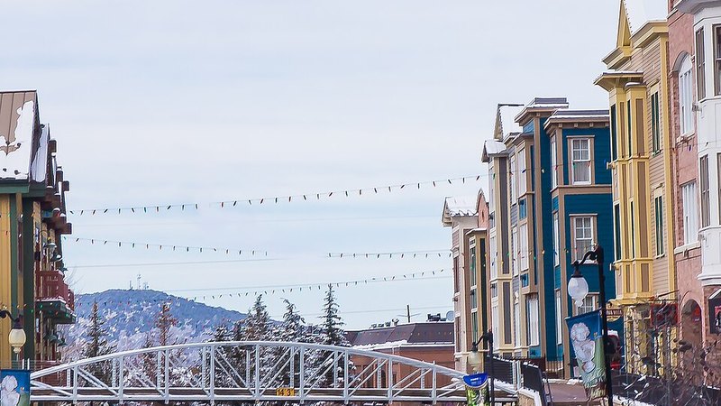 Snowy Main Street with colorful storefronts in Park City, Utah