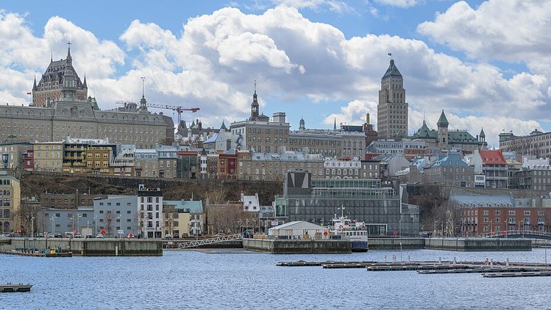 Quebec City waterfront and hillside buildings, including Château Frontenac, across the St. Lawrence River.