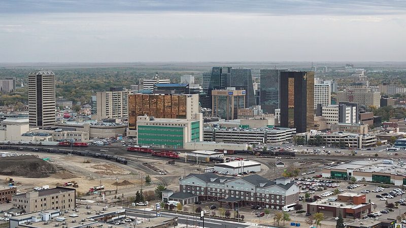 Aerial view of downtown Regina, Saskatchewan, with office towers and railway tracks.