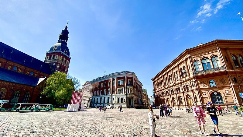 Historic square and church tower in Riga Old Town, Latvia.