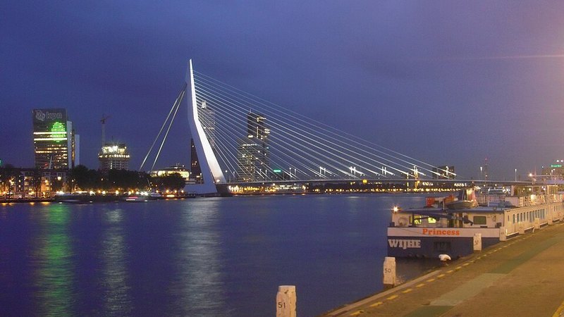 The illuminated Erasmus Bridge across the river in central Rotterdam