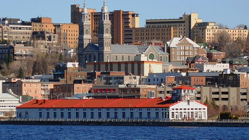 Waterfront buildings and twin church towers in Chicoutimi, a borough of Saguenay.
