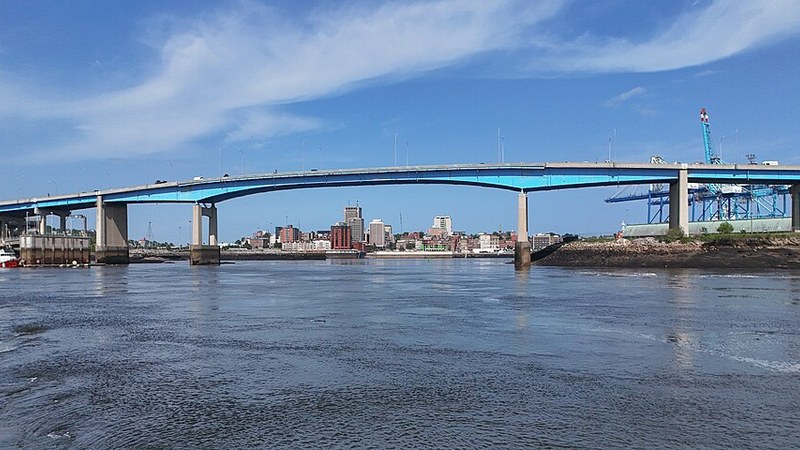 Saint John Harbour Bridge spans the water with the New Brunswick city skyline beyond.