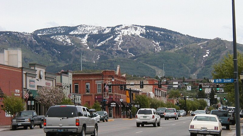 Downtown Steamboat Springs with snow patches on the mountain behind, Colorado.