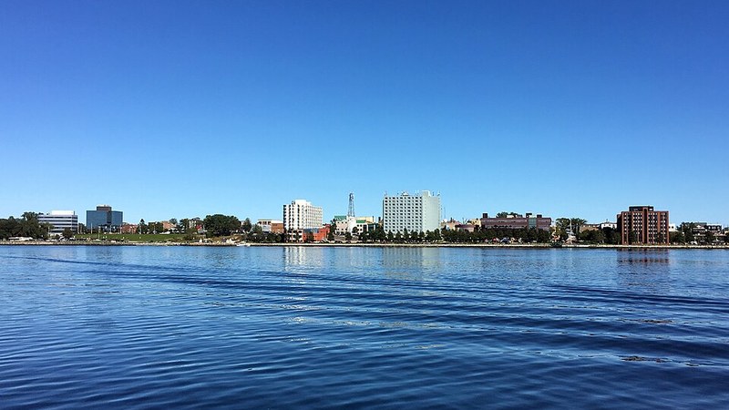 Downtown Sydney, Nova Scotia, stretching along the harbour beneath a clear blue sky.