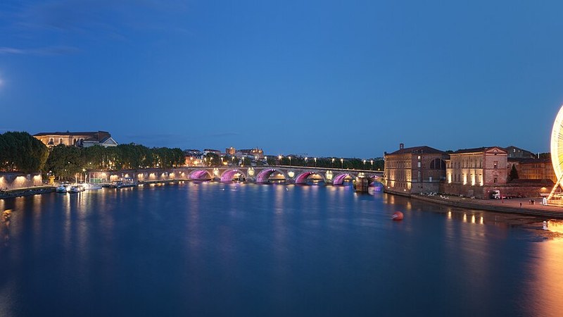 Toulouse riverfront and bridges at dusk, France.