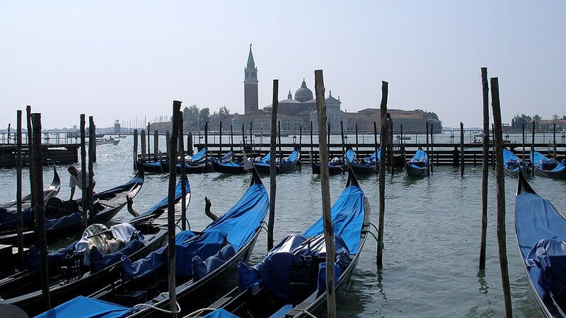 Gondolas moored across the water from San Giorgio Maggiore in Venice, Italy.