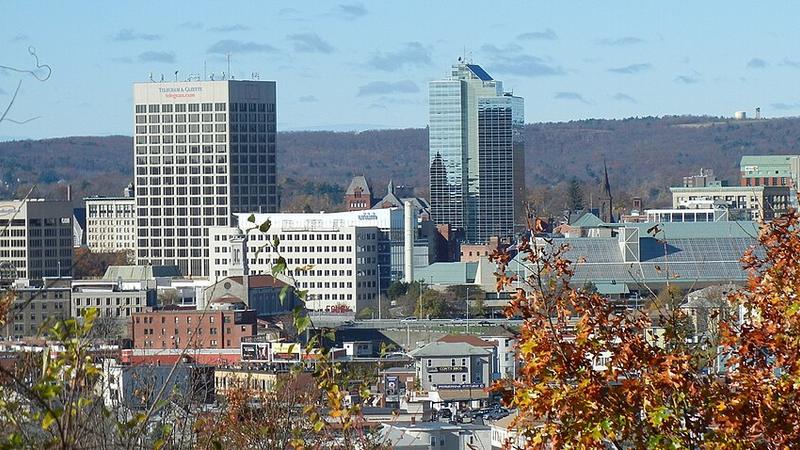 Downtown Worcester, Massachusetts, skyline framed by autumn foliage.
