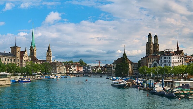 Zürich's riverfront and historic church towers viewed from Quaibrücke, Switzerland.